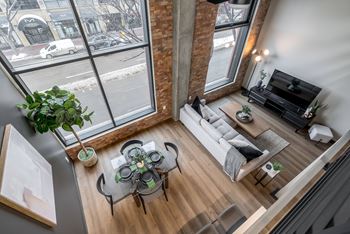 A living room with a glass table and a white couch.
